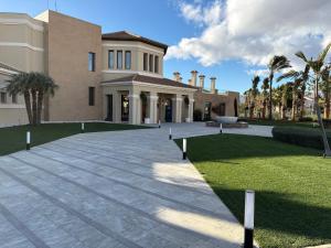 a large building with palm trees in front of it at Sonne - Golf - 4Pers - Komfort - Apartments in Fuente-Álamo de Murcia