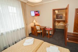 Postel nebo postele na pokoji v ubytování Hotel przy Młynie