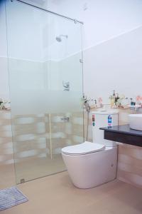 a bathroom with a toilet and a glass shower at Scenic View - Ella in Ella