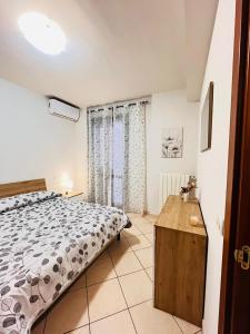 a bedroom with a large bed and a wooden table at Elisabeth home in Modica