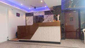 a lobby of a building with a counter and a door at HoTEL JAGAPATHI INTERNATIONAL in Vijayawāda