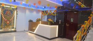 a room with a stage with a white table and flowers at HoTEL JAGAPATHI INTERNATIONAL in Vijayawāda +10 photos