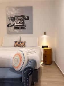 a bedroom with a bed with a telephone on it at Myronos suite with jacuzzi in Piraeus +31 photos