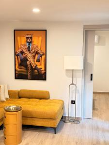 a living room with a couch and a painting of a monkey at Myronos suite with jacuzzi in Piraeus
