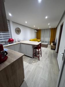 a kitchen with a table in the middle of a room at L'Aparté des hibiscus in Les Trois-Îlets