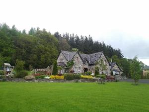 a large house in a field with a green yard at Drumhierney Lodge in Leitrim