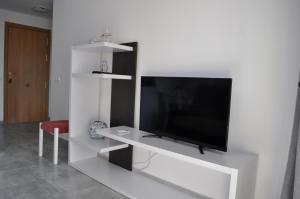 a living room with a tv on a white wall at Apartment Eva Mar in Benidorm