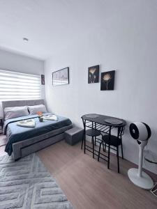 a bedroom with a bed and a table and chairs at Charming & Comfortable Studio Haven in Lapu Lapu City +24 photos