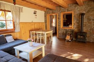 a living room with a couch and a table at Chata Lienka in Lazisko