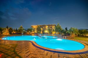 a large swimming pool in front of a building at Hotel La vena in Kampala