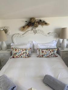 a bedroom with a white bed with pillows at West mouse view in Holyhead