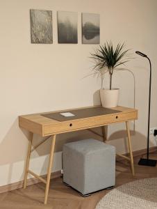 a wooden desk with a potted plant on top of it at Alte Remise Blankenburg in Blankenburg +19 photos