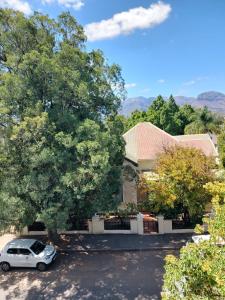 a car parked in a parking lot in front of a house at The Botanic Venus in Paarl