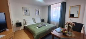 a bedroom with a bed with a table and a television at Gästehaus Mittmann in Bad Kissingen