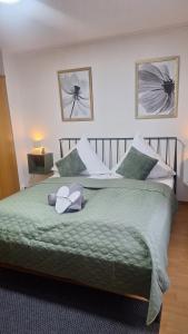 a bedroom with a bed with a teddy bear on it at Gästehaus Mittmann in Bad Kissingen