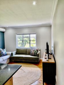 a living room with a couch and a table at The Botanic Venus in Paarl