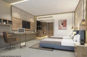 a bedroom with a bed and a desk with a laptop at Hotel Shubham Prestige RC Puram in Lingampalli