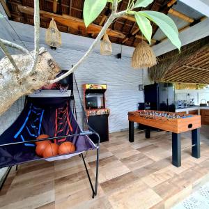 a room with a ping pong table and a table at Rumah Kayu Sari in Mengwi