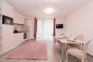 a kitchen and dining room with a table and chairs at White Valey Retreat One in Buşteni +4 photos