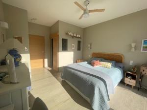 a bedroom with a bed and a ceiling fan at 1 Brin à part in Maubec