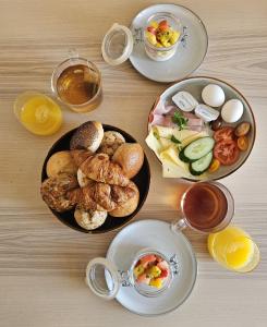 a table with plates of breakfast foods and drinks at Skip Inn Strandhuisjes in Katwijk aan Zee +25 photos