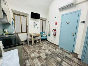 a room with a blue door and a table at The Blue Nest Suite - Sanremo in Sanremo +4 photos