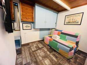 a living room with a couch and a tv at The Blue Nest Suite - Sanremo in Sanremo