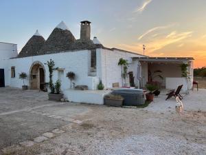a large white building with a sunset in the background at Villa Filou in Santa Lucia