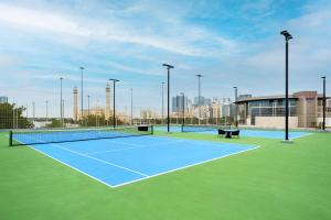 a tennis court with two benches on top of it at Gulf Executive Residence in Manama