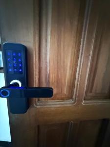 a door with a remote control sticking out of it at Dana's Room in Dar es Salaam