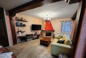 a living room with a couch and a fireplace at Apartamentos Fuentevieja in Arbancón