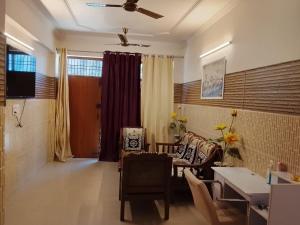 a living room with a couch and a table at Esadan in Agra