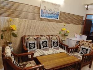 a dining room with a table and chairs at Esadan in Agra