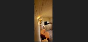 a corridor of a hotel room with orange chairs at BelleLiv in Nijlen