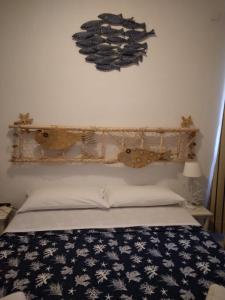 a bedroom with a bed and a shelf on the wall at La Dea Madre in Stintino +24 photos