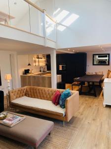 a living room with a couch and a dining room at Peartree Cottage in Sandhoe