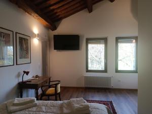 a living room with a couch and a table and windows at Podere Misericordia in Ferrara +39 photos