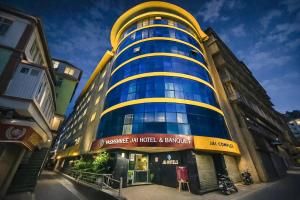 a building with a blue and yellow building at Yashshree Jai Hotel & Banquet in Darjeeling
