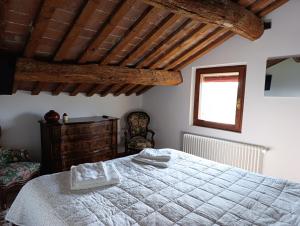 a bedroom with a white bed and a window at Podere Misericordia in Ferrara