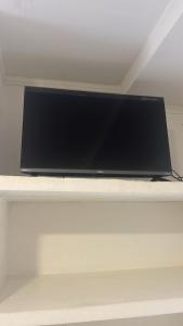 a flat screen tv sitting on top of a shelf at Pousada Nascer do Sol in Marau
