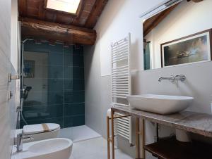 a bathroom with a sink and a glass shower at Podere Misericordia in Ferrara