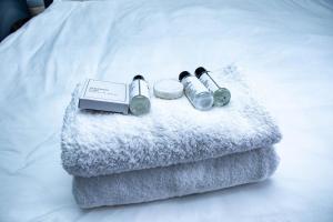 a pair of headphones sitting on top of a bed at The River Boutique Inn in Lobamba