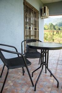 a table and two chairs and a table and chairs at The River Boutique Inn in Lobamba