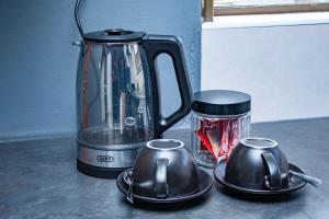 a blender sitting on top of a counter with two dishes at The River Boutique Inn in Lobamba