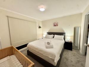 a bedroom with a bed with a towel on it at Private Farmhouse & Paddock Available in Werribee South