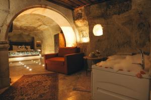 a living room with a couch and a fireplace at Tale Cave İnn in Ürgüp