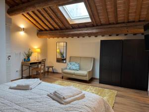 a bedroom with a bed and a chair and a desk at Podere Misericordia in Ferrara