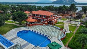 an aerial view of a house with a swimming pool at Palm Cove Resort And Spa in Jāmb