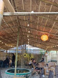 a group of people sitting in chairs under a roof at Ratnagiri Boutique Hotel in Mirik