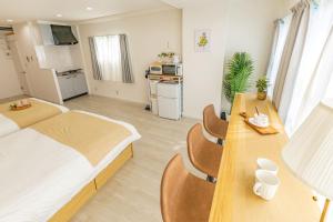 a bedroom with a bed and a table with chairs at night-night 東京ドーム便利 江戸川橋駅近 池袋銀座直通 商店街徒歩圏内 in Tokyo
